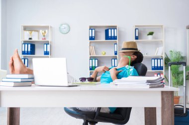 İş adamı ofiste tatile hazırlanıyor.