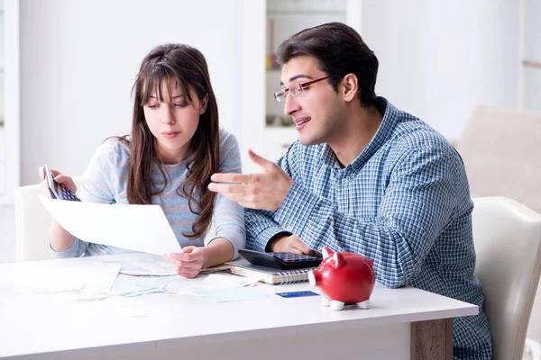 Young couple looking at family finance papers — Stock Photo, Image