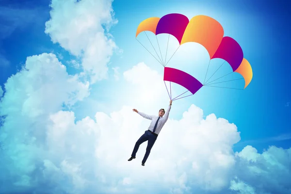 Молодий бізнесмен падає на парашут в бізнес-концепції — стокове фото
