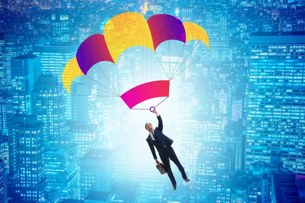 Молодой бизнесмен упал на парашют в бизнес-концепции — стоковое фото