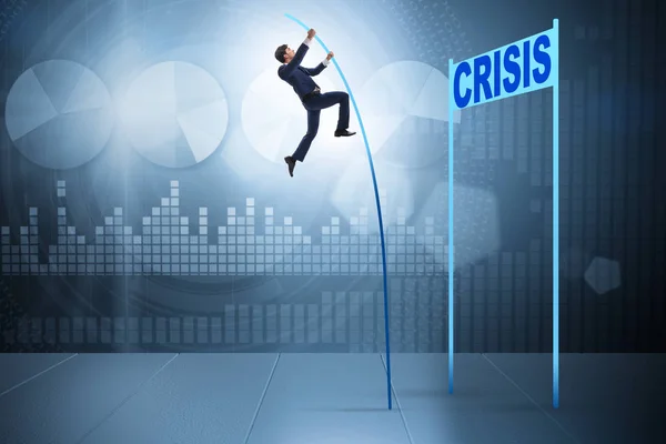 Businessman pole vaulting over crisis in business concept — Stock Photo, Image