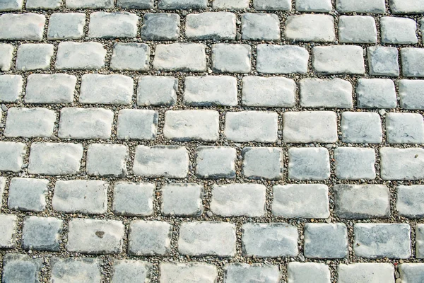 Droga wybrukowana brukowanymi kamieniami na tło — Zdjęcie stockowe