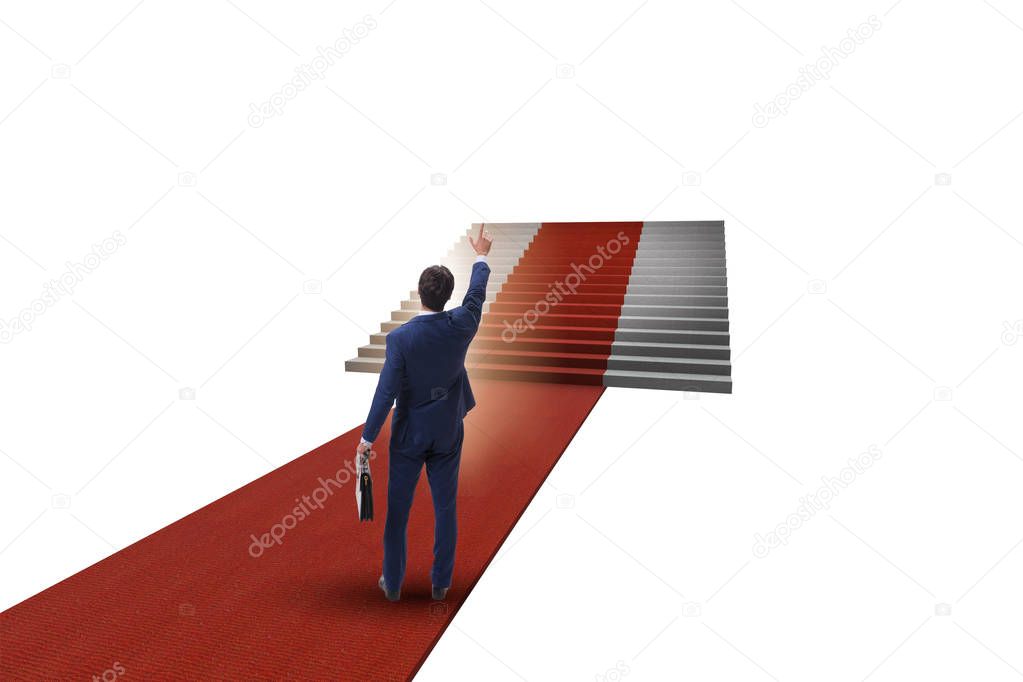Young businessman climbing stairs and red carpet on white backgr