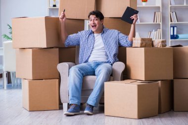 Young man moving in to new house with boxes clipart