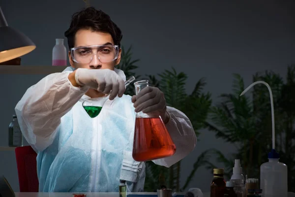 Young male lab chemist late at night in overtime time — Stock Photo, Image