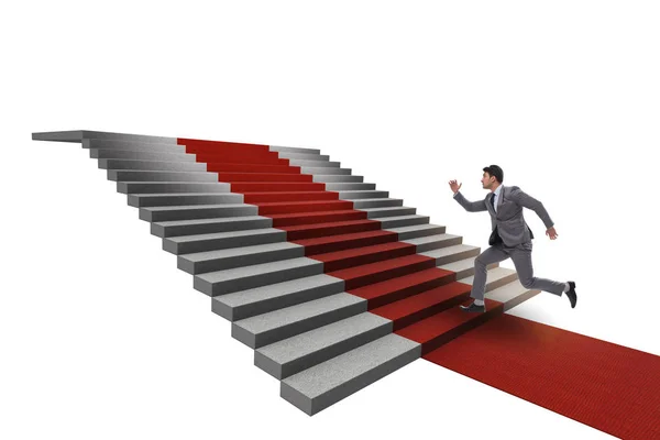 Joven empresario subiendo escaleras y alfombra roja sobre fondo blanco — Foto de Stock