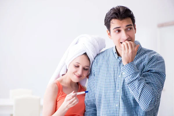 Wife and husband looking at pregnancy test — Stock Photo, Image