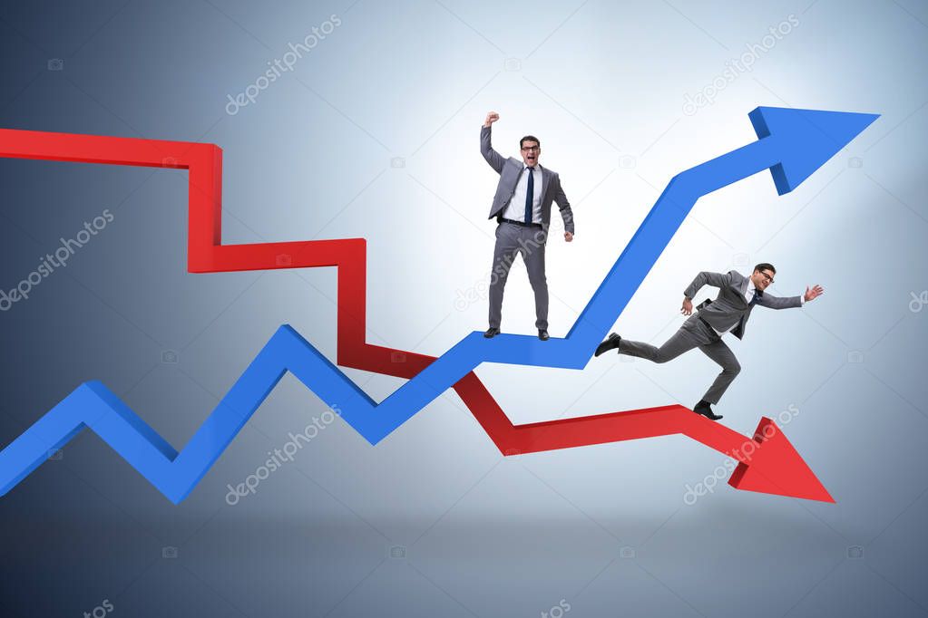 Businessman with charts of growth and decline