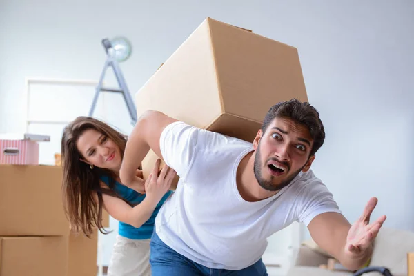 Young family unpacking at new house with boxes — Stock Photo, Image