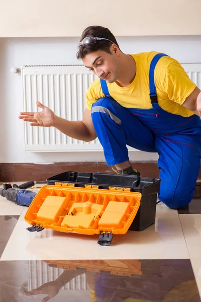 Young repairman contractor repairing heating panel — Stock Photo, Image