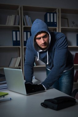 Genç hacker geceleri bilgisayarı hackliyor.