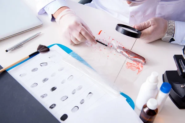 Criminologist police chemist looking at crime evidence — Stock Photo, Image