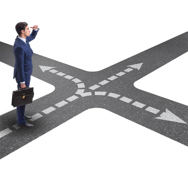 Young businessman at crossroads in uncertainty concept — Stock Photo, Image