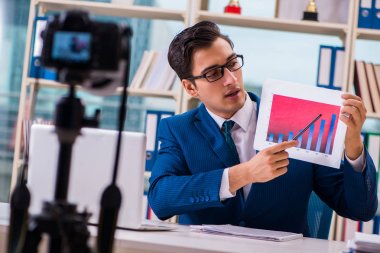 Businessman recording a video for vlog clipart