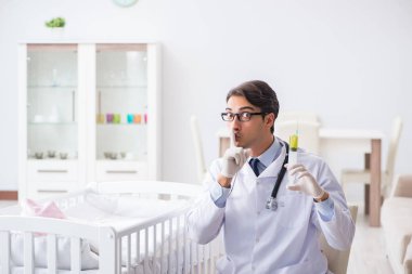 Doktor bebek aşısı için hazırlanıyor.