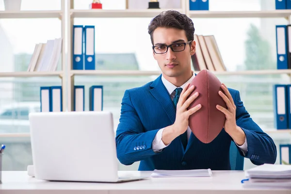 Zakenman met Amerikaans voetbal in functie — Stockfoto