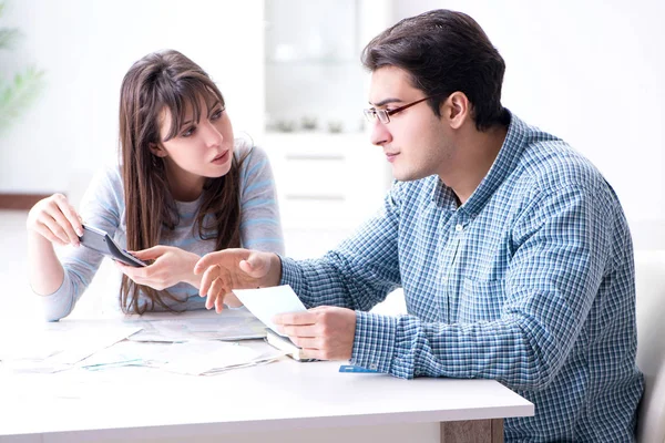 Young couple looking at family finance papers — Stock Photo, Image