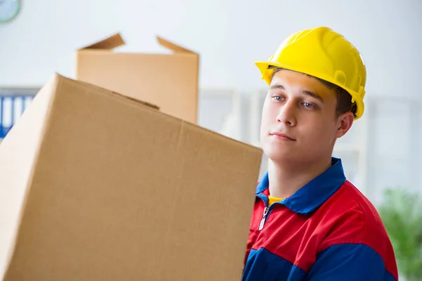 Young man working in relocation services with boxes — Stock Photo, Image