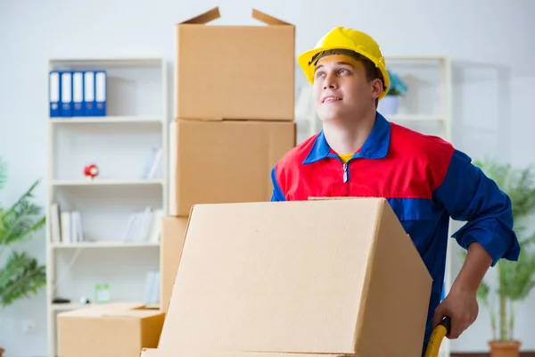 Young man working in relocation services with boxes — Stock Photo, Image
