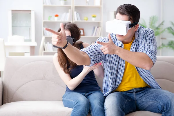 Young family playing games with virtual reality glasses