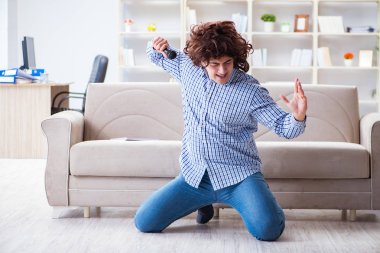 Evde karaoke yapan komik adam.