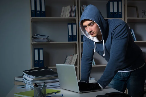 Young hacker hacking into computer at night — Stock Photo, Image