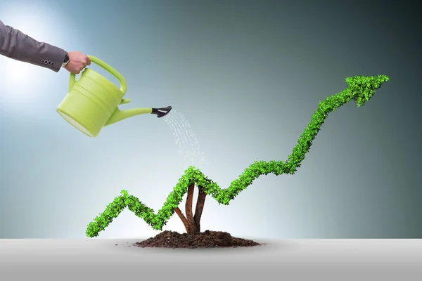 Businessman in investment concept watering financial line chart — Stock Photo, Image