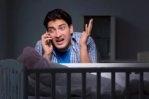 Young father under stress due to baby crying at night — Stock Photo, Image