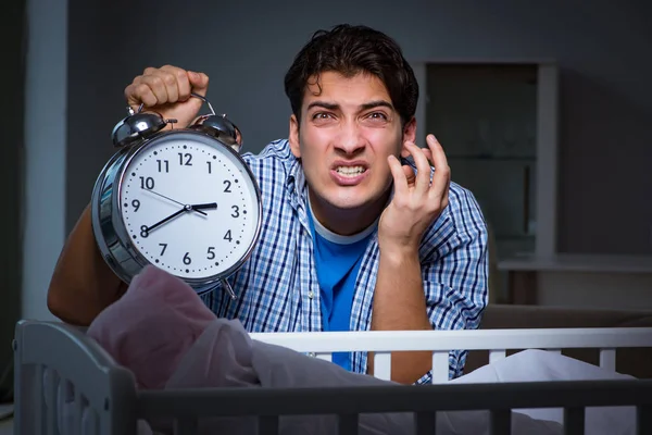 Young father under stress due to baby crying at night