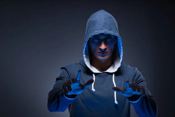 Young man wearing hoodie pressing virtual buttons — Stock Photo, Image