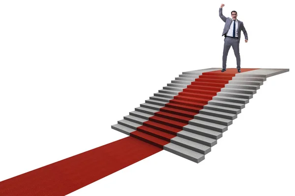 Young businessman climbing stairs and red carpet on white backgr — Stock Photo, Image