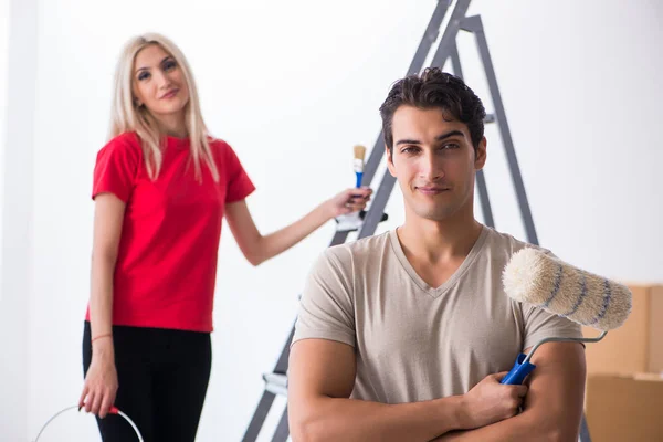 Joven familia haciendo trabajo de pintura durante la renovación del hogar —  Fotos de Stock