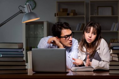 İki öğrenci geç saatlere kadar çalışıp sınavlara hazırlanıyor.