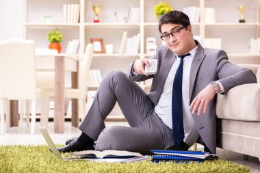 İş adamı evde yerde çalışıyor.