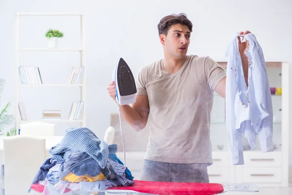 Unaufmerksamer Ehemann verbrennt Kleidung beim Bügeln — Stockfoto