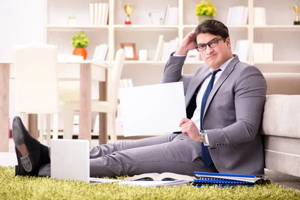 Businessman working on the floor at home — Stock Photo, Image