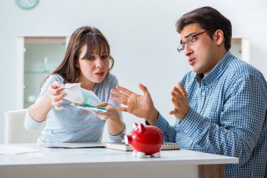 Young couple looking at family finance papers clipart