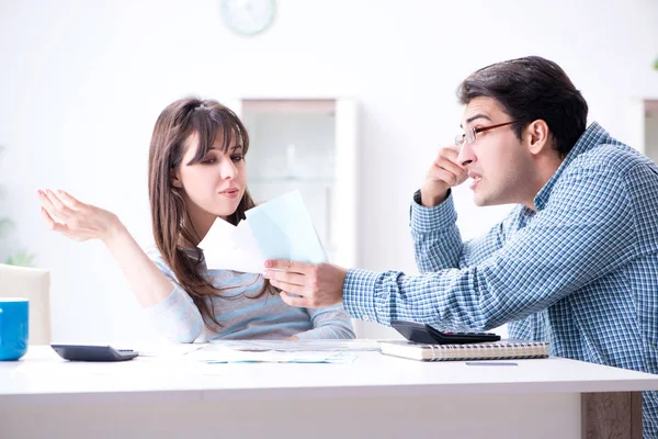 Junges Paar schaut auf Familienfinanzierungspapiere — Stockfoto