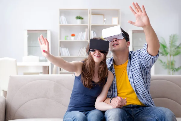 Young family playing games with virtual reality glasses