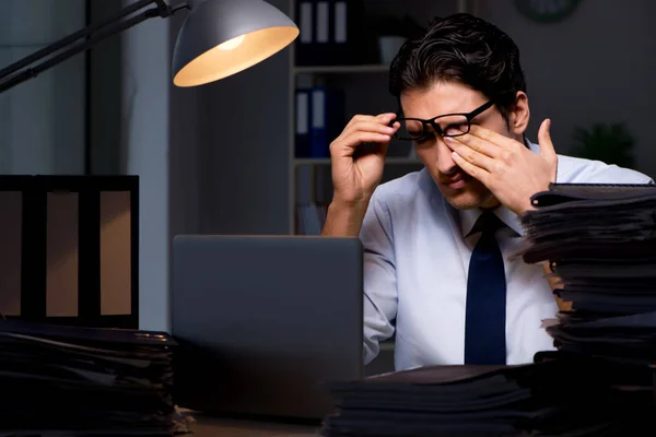 Young businessman working overtime late in office