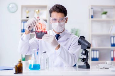 Hastane kliniğinde kan örnekleriyle çalışan bir doktor.