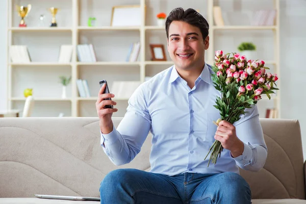 Young man chatting with his sweetheart over mobile phone