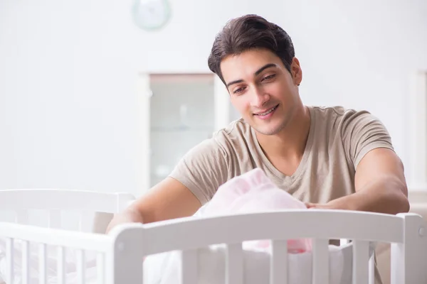 Jonge vader genieten van tijd met pasgeboren baby thuis — Stockfoto