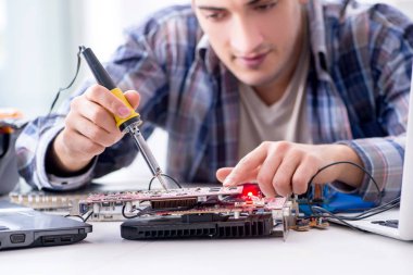 profesyonel tamirci atölyede bilgisayar tamir ediyor.