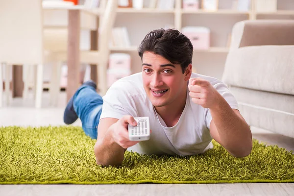 Muž kouká na televizi doma na podlaze — Stock fotografie