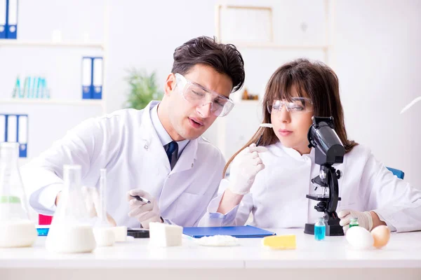 Two lab doctor testing food products