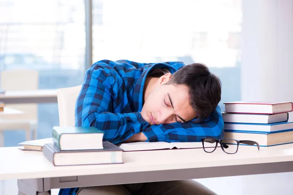 Student studying in the empty library with book preparing for ex — Stock Photo, Image