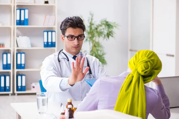 Doctor talking to cancer patient in hospital