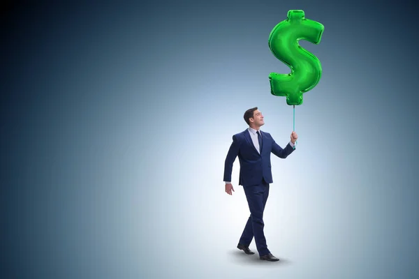 Geschäftsmann läuft mit aufblasbarem Dollarzeichen — Stockfoto