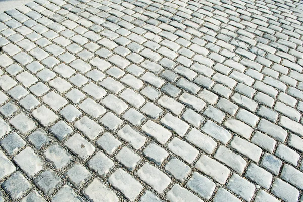 Camino pavimentado con piedras de guijarro para su fondo —  Fotos de Stock